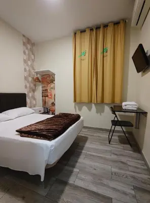 Una televisión o centro de entretenimiento en JQC Rooms