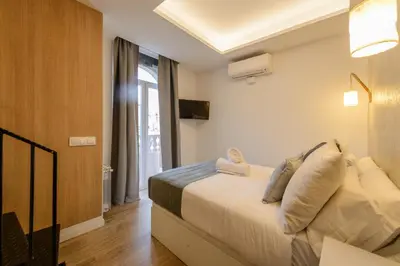 Cama o camas de una habitación en Gran Vía Capitals Residences - by MONARO