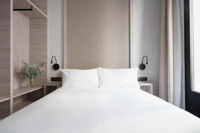 Cama o camas de una habitación en Numa Madrid Luna