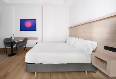 Cama o camas de una habitación en Numa Madrid Goya