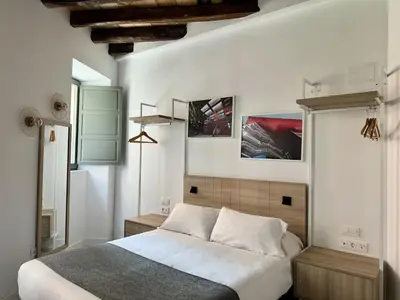 Cama o camas de una habitación en CavaBajaSuites