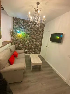 Una televisión o centro de entretenimiento en Gran Vía Urban Apartments