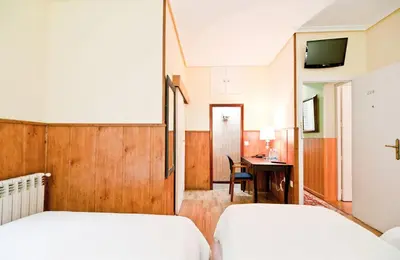 Cama o camas de una habitación en Hostal Asunción