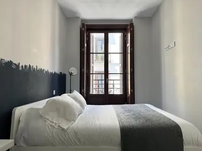 Cama o camas de una habitación en PlazaMayorSuites