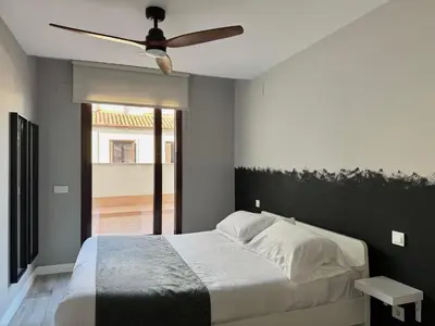 Cama o camas de una habitación en PlazaMayorSuites
