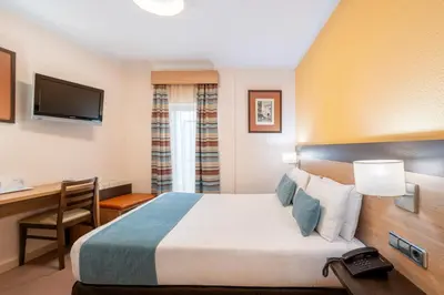 Cama o camas de una habitación en Hostal Ballesta