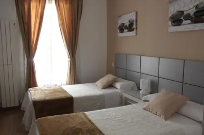 Cama o camas de una habitación en Casa de Huéspedes Galaica