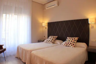 Cama o camas de una habitación en Hostal Oriente