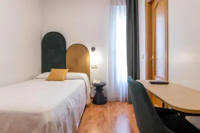 Cama o camas de una habitación en Hostal Oriente
