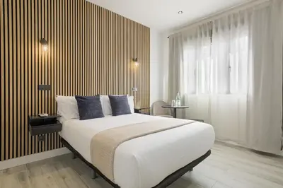 Cama o camas de una habitación en Dobo Madrid Lucero