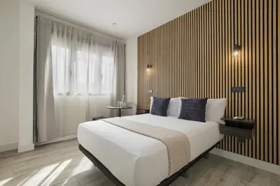 Cama o camas de una habitación en Dobo Madrid Lucero