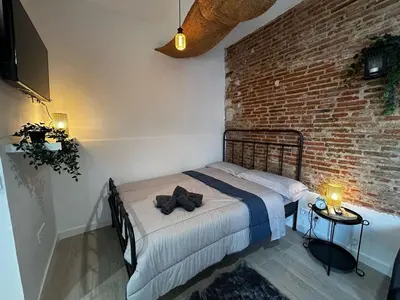 Cama o camas de una habitación en Hermoso apartamento estudio en el centro de Madrid