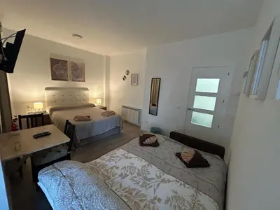 Cama o camas de una habitación en Habitaciones en Embajadores