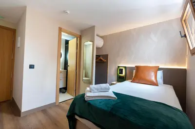 Cama o camas de una habitación en Negresco Plaza Mayor