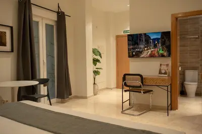 Una televisión o centro de entretenimiento en Suites You Opera