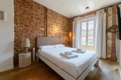 Cama o camas de una habitación en Waou Chueca V - Alquiler Corta Duración