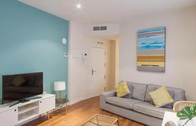 Una televisión o centro de entretenimiento en Apartamentos Gran Vía