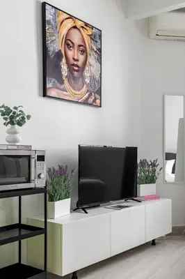 Una televisión o centro de entretenimiento en Sweet Home Madrid