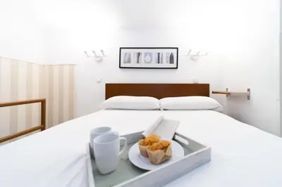Cama o camas de una habitación en Apartamentos Puerta Del Sol I
