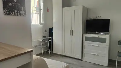 Una televisión o centro de entretenimiento en Loft cerca de plaza de toros