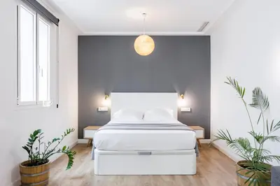 Cama o camas de una habitación en Home Suite Home Gran Via, en pleno centro