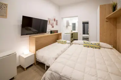 Cama o camas de una habitación en Cozy studio in Chamberí