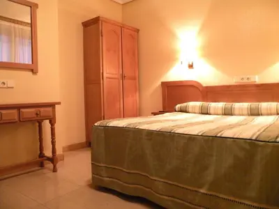 Cama o camas de una habitación en Hostal Benamar