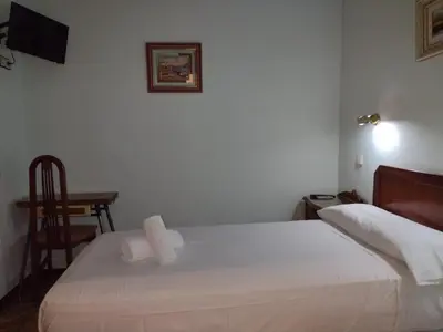 Cama o camas de una habitación en Hostal Sardinero