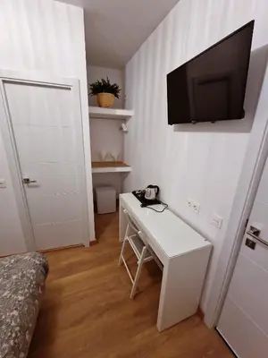 Una televisión o centro de entretenimiento en Hostal A Nuestra Senora de La Paloma