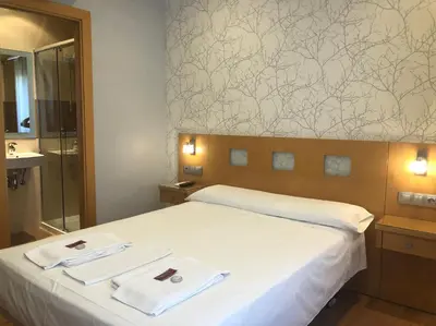 Cama o camas de una habitación en Hostal Abami II