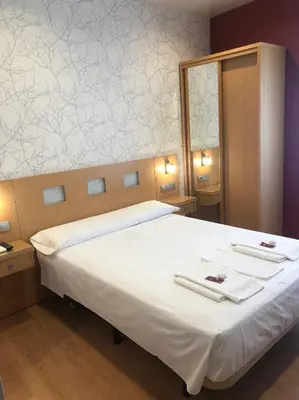 Cama o camas de una habitación en Hostal Abami II