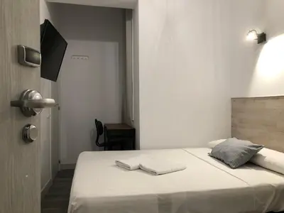 Cama o camas de una habitación en Hostal Abami II
