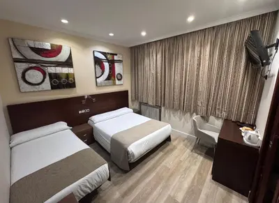 Cama o camas de una habitación en Hostal Atocha Almudena Martín