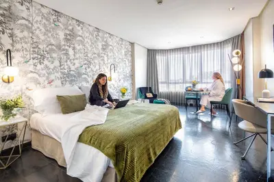 Cama o camas de una habitación en Apartosuites Jardines de Sabatini