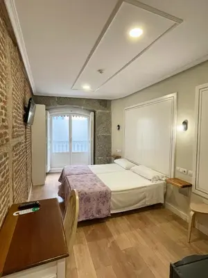 Cama o camas de una habitación en Hostal Madrid