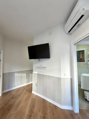 Una televisión o centro de entretenimiento en Apartamentos Mayor Centro