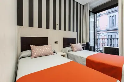 Cama o camas de una habitación en Hostal Castilla I Atocha