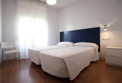 Cama o camas de una habitación en Hostal Santa Isabel