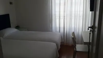 Cama o camas de una habitación en Hostal Santa Isabel