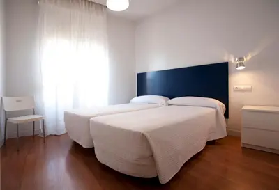 Cama o camas de una habitación en Hostal Santa Isabel