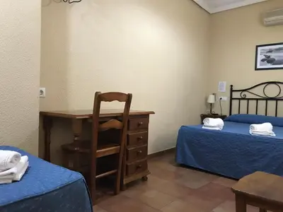 Cama o camas de una habitación en Hostal El Pilar