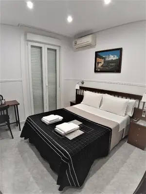 Cama o camas de una habitación en Hostal Dulcinea