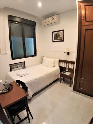 Cama o camas de una habitación en Hostal Dulcinea