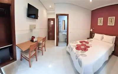 Cama o camas de una habitación en Hostal Dulcinea