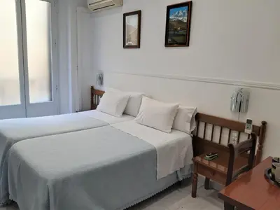 Cama o camas de una habitación en Hostal Dulcinea