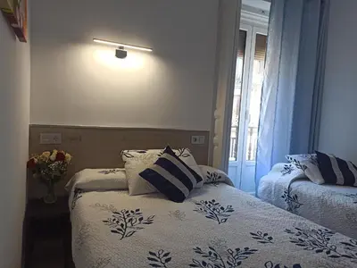 Cama o camas de una habitación en Hostal Huespedes Toledo