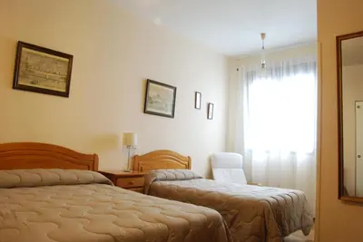 Cama o camas de una habitación en Hostal America