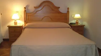 Cama o camas de una habitación en Hostal Maria Cristina