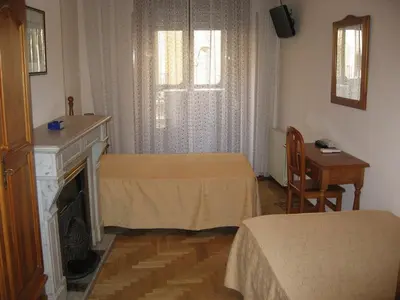 Cama o camas de una habitación en Hostal Maria Cristina