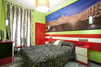 Cama o camas de una habitación en JC Rooms Santa Ana